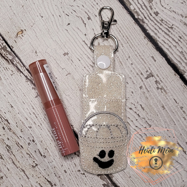 Halloween Pail Ghost lip balm holder snap tab shown with lipstick