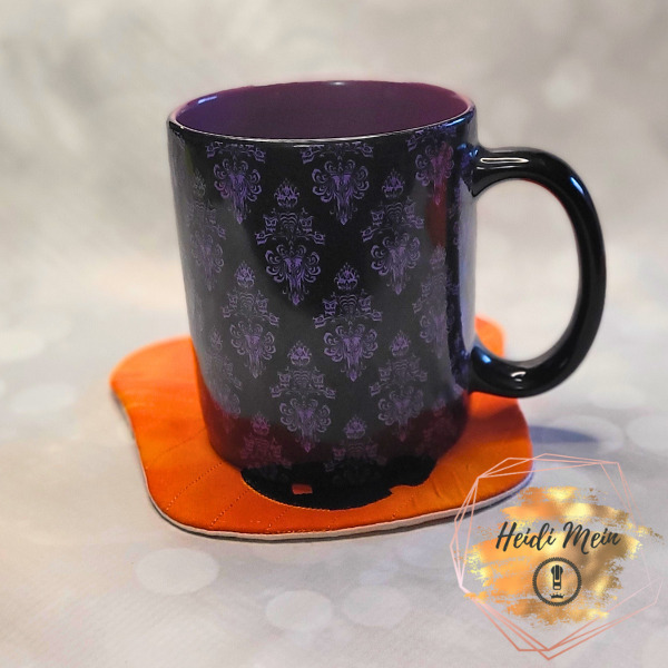 Halloween Pail Pumpkin Mug Rug shown with cup