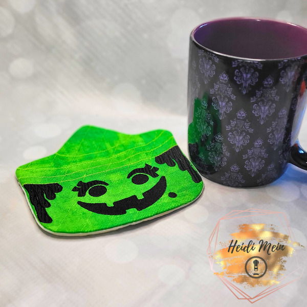 Halloween Pail Witch Mug Rug shown next to cup