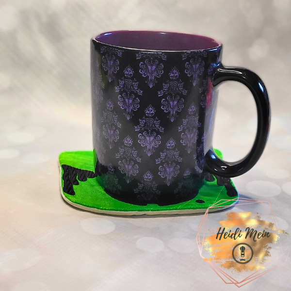 Halloween Pail Witch Mug Rug shown with cup